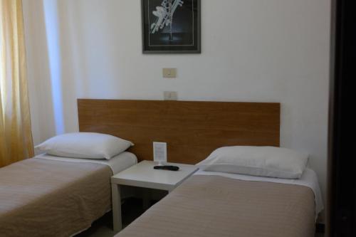 A bed or beds in a room at Hotel Houston Livorno - Struttura Esclusivamente Turistica - Not for Business or Workers