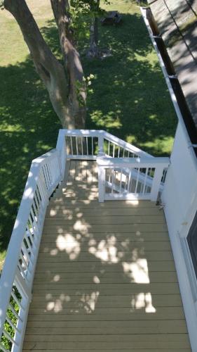 a wooden stairway with a white bench on a house at Wades Point Inn on the Bay in Saint Michaels