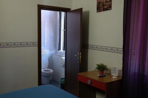a bathroom with a bed and a toilet and a window at Hotel Houston Livorno - Struttura Esclusivamente Turistica - Not for Business or Workers in Livorno