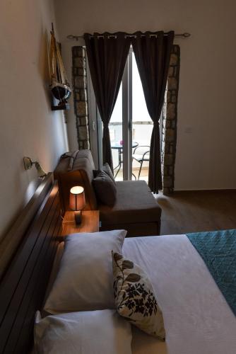 a bedroom with two beds and a window with a patio at Villa Dulcinea in Ulcinj
