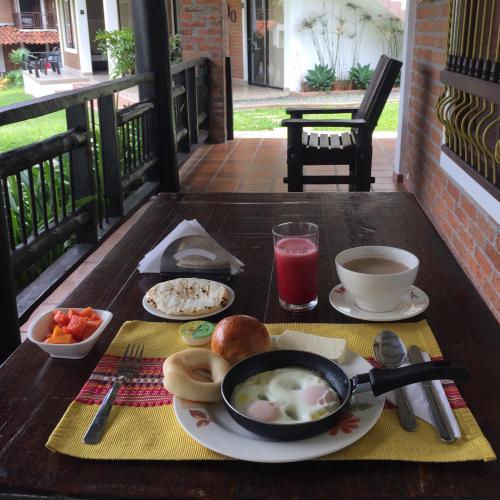 a table with a bowl of soup and a bowl of food at Finca Hotel Casa Nostra, villa Mariana in Quimbaya