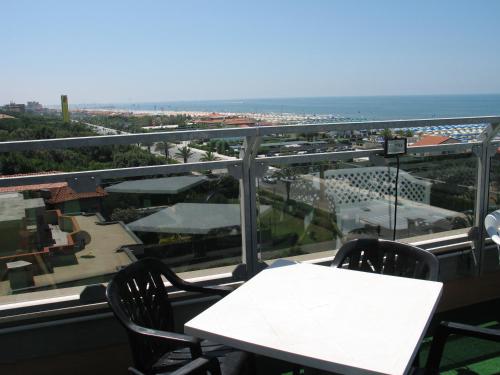 a table and chairs on a balcony with a view at Hotel Bixio in Lido di Camaiore
