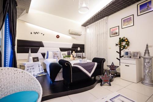 a room with a bed and a table and chairs at 巴黎Villa 主題派對K歌 BBQ 麻將包棟 in Luodong