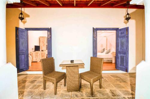 a table and chairs in a room with a bedroom at Handun Villas in Talalla