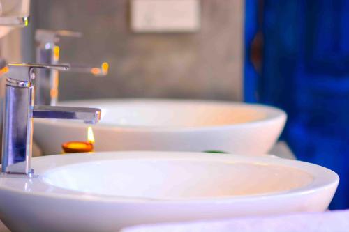 a white sink with a faucet in a bathroom at Handun Villas in Talalla