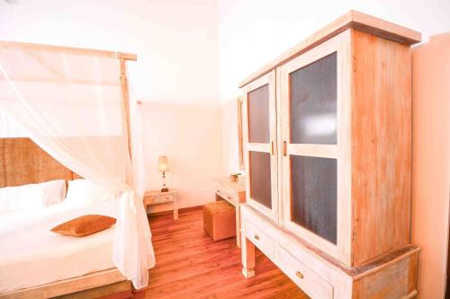 a bedroom with a canopy bed and a window at Handun Villas in Talalla