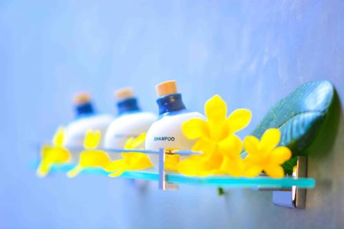 a shelf with four bottles of detergents on it at Handun Villas in Talalla