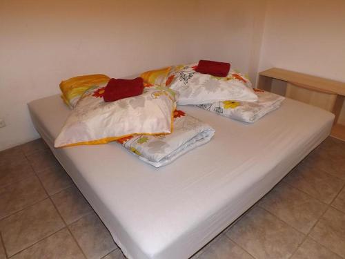 a bed with four pillows on top of it at 10 os - Gdansk-Sopot-Gdynia up to 19 persons in Gdynia
