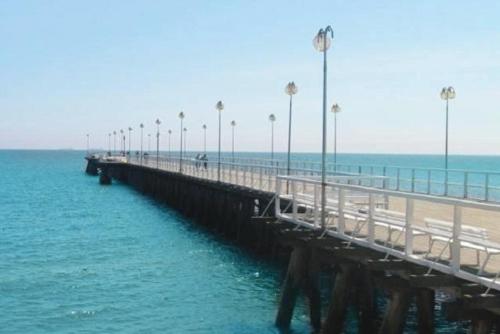 a pier with a beach with palm trees and the ocean at 10 os - Gdansk-Sopot-Gdynia up to 19 persons in Gdynia