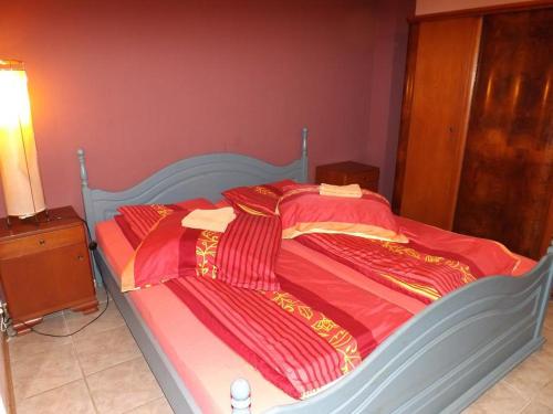 a bed with red and yellow blankets on it at 10 os - Gdansk-Sopot-Gdynia up to 19 persons in Gdynia