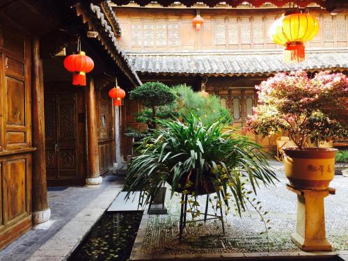 a courtyard with plants and lanterns in a building at Artistic-Suite in Lijiang