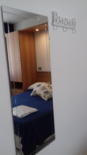 a mirror reflection of a bed in a bedroom at Villa Laura Residence Hotel Apartments & Studios in Ascea