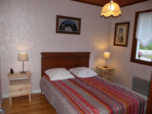 a bedroom with a bed with two night stands and two lamps at Chalet Roche Rousse in Gresse-en-Vercors