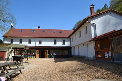 a large white building with a picnic table next to it at Zrcadlová Koza in Turnov