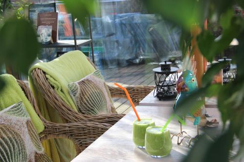 a table with two green drinks on top of it at SeaPark Hotel Wellness & Spa in Kołobrzeg