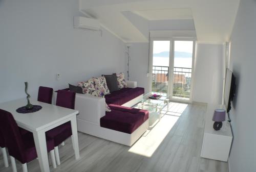 a living room with a couch and a table at Apartments MM in Sveti Stefan