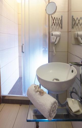 a bathroom with a sink and a shower at Studios Marios in Kamari