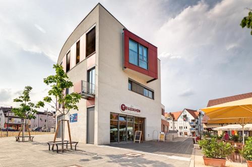 a building with a red window on the side of it at Hotel La Ferté in Stuttgart
