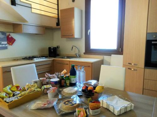 a kitchen with a table with food on it at Agriturismo Casalbergo in Isola della Scala
