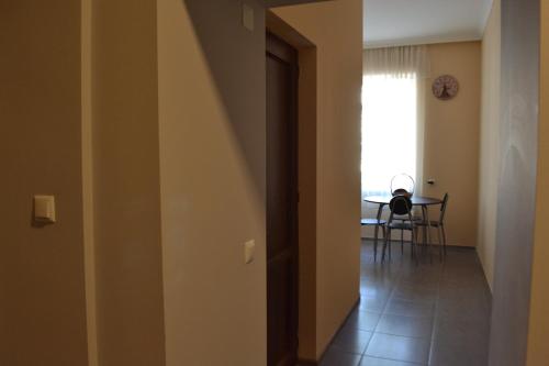 a hallway with a table and a dining room at Comfortable Apartment close to Central Park in Tskaltubo