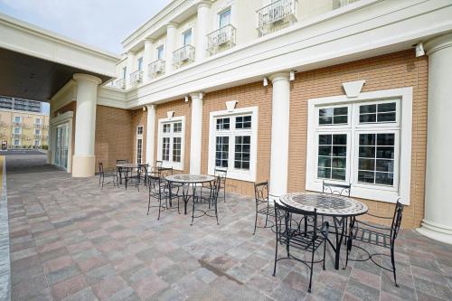 a patio with tables and chairs in front of a building at La'gent Hotel Tokyo Bay in Urayasu