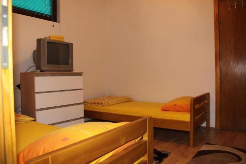 a room with two bunk beds and a television at VIP Rooms Foča, Accommodation Foca, Foca Rooms in Foča