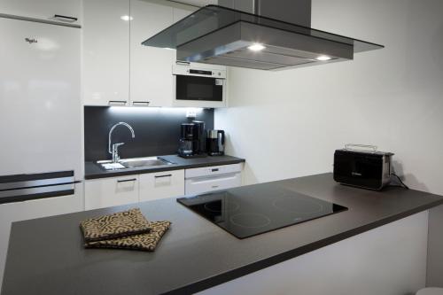 a kitchen with a sink and a counter top at Holiday Club Himos Superior Apartments in Jämsä