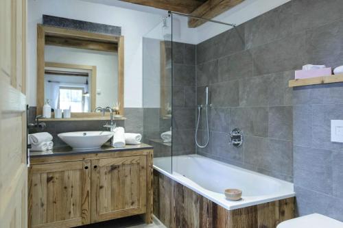 a bathroom with a tub and a sink at Residence Mitterdorfer in Abfaltersbach