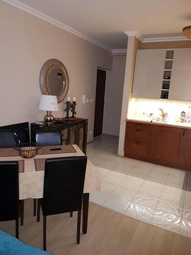 a living room with a table and a mirror at Zamardiresort in Zamárdi