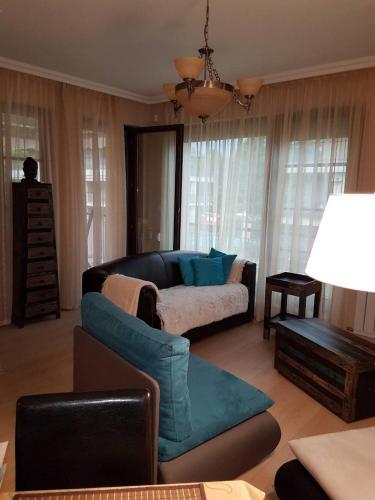 a living room with a couch and a table at Zamardiresort in Zamárdi