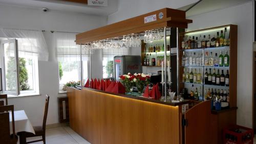 a bar with red umbrellas and bottles of wine at Ośrodek SCSK Optima in Kraków