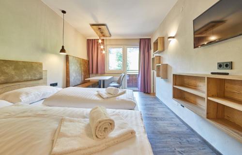 a hotel room with two beds with towels on them at Appartement Bella Vista in Saalbach-Hinterglemm