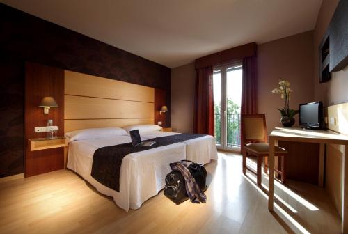 Кровать или кровати в номере Hotel Villa Blanca