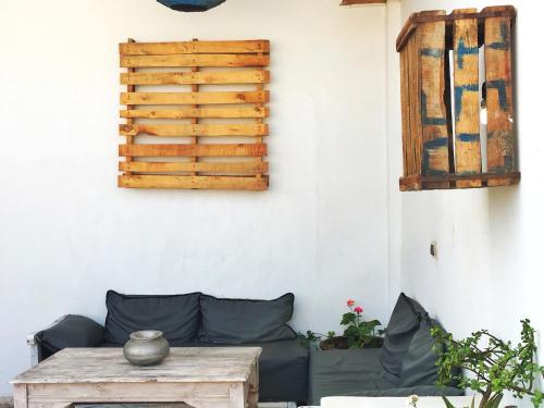 a living room with a couch and a table at Riad Inna & Watersports Center in Essaouira