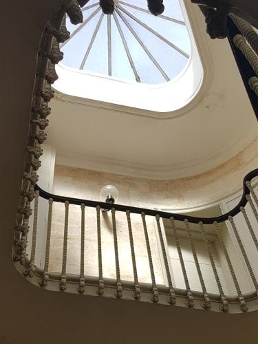 a spiral staircase with a skylight in a building at La loge des Salinières in Bordeaux