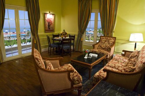 a living room with a couch and chairs and a table at Helnan Auberge Fayoum in Fayoum Center