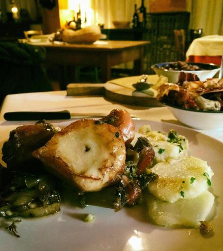 a plate of food with meat and vegetables on a table at Biss Badaliss - Bed & Breakfast in Valdobbiadene