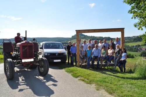 a group of people posing for a picture next to a tractor at Appartementhaus Thermeneck in Laa an der Thaya