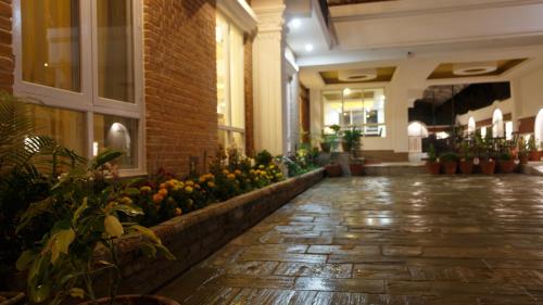 a hallway of a building with flowers and plants at DOM Himalaya Hotel in Kathmandu