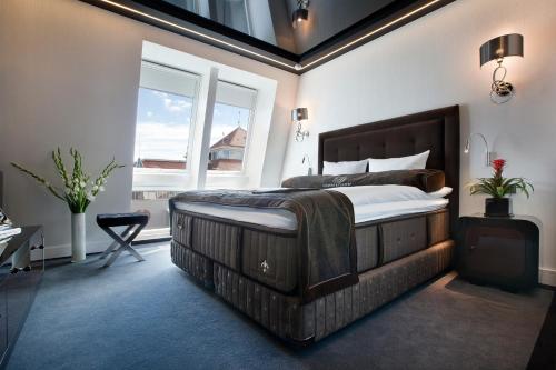 a bedroom with a large bed and a window at Bayjonn Boutique Hotel in Sopot