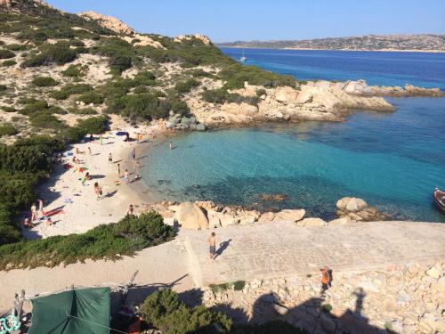 a group of people on a beach near the water at Stazzo Serafini in Rena Majore