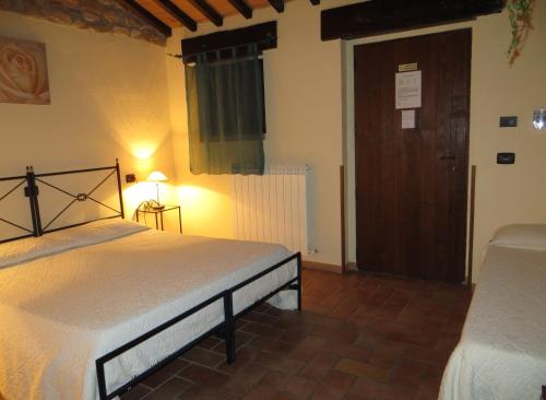 a bedroom with a bed in a room with a door at Agriturismo Casale delle Lucrezie in Todi