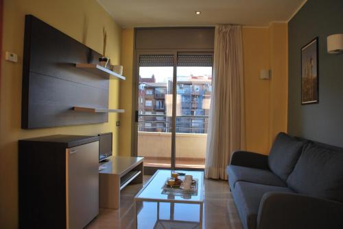 a living room with a couch and a tv at Apartaments Independencia in Barcelona