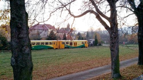 a yellow and green bus parked in a field at Apartments České Středohoří in Teplice