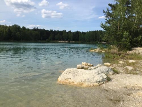 a lake with some rocks in the water at Ferienwohnung Niesky in Niesky