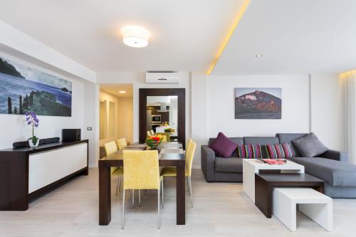 a living room with a couch and a table at Royal Sun Resort in Acantilado de los Gigantes