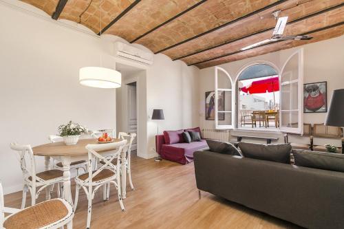 a living room with a table and a couch at Bcn Paseo De Gracia Rocamora Apartment in Barcelona