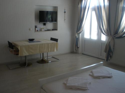 a room with a table and a television and a window at Apartment Gogi in Vodice