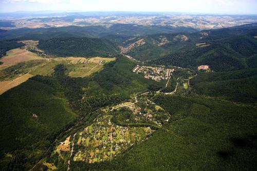 an aerial view of a forested area with houses at Öko-Park Panzió, Kemping és Rendezvényközpont in Szarvaskő