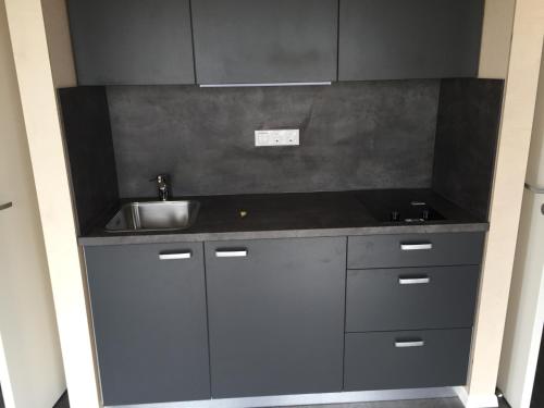 a kitchen with a sink and a counter top at Welcome Holiday Home in Eyvindarhólar